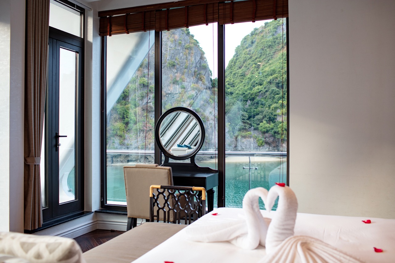 Luxury hotel room with scenic river and mountain views in Vietnam.