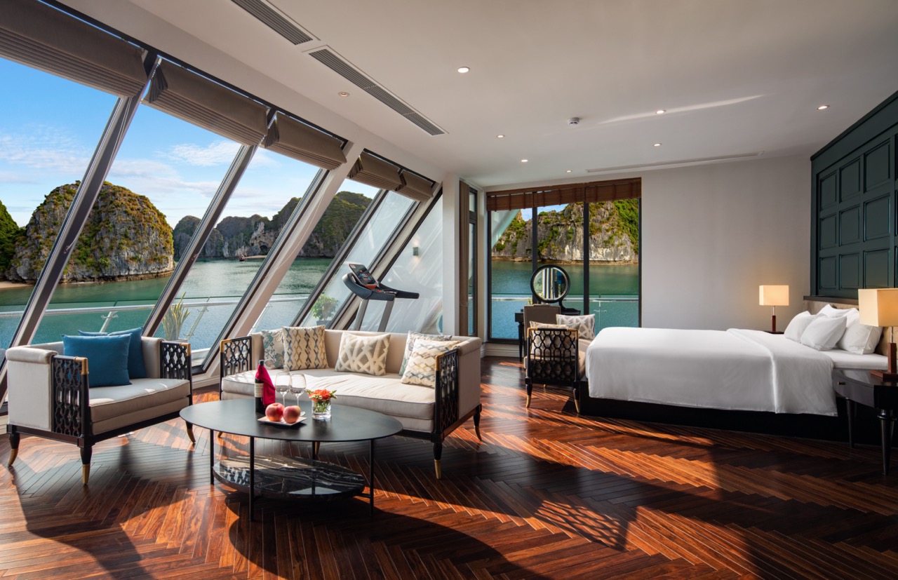 Stunning luxury hotel room with panoramic water views and elegant furnishings.