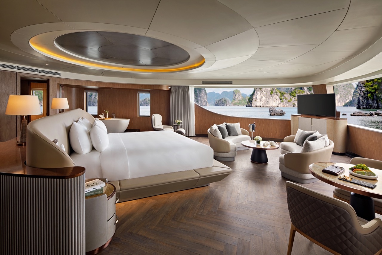 Luxury cruise ship interior with panoramic ocean views and modern furnishings.