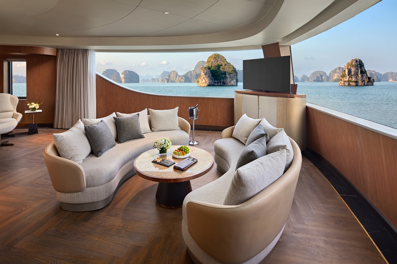 Luxurious cruise lounge with panoramic sea views and elegant furnishings.