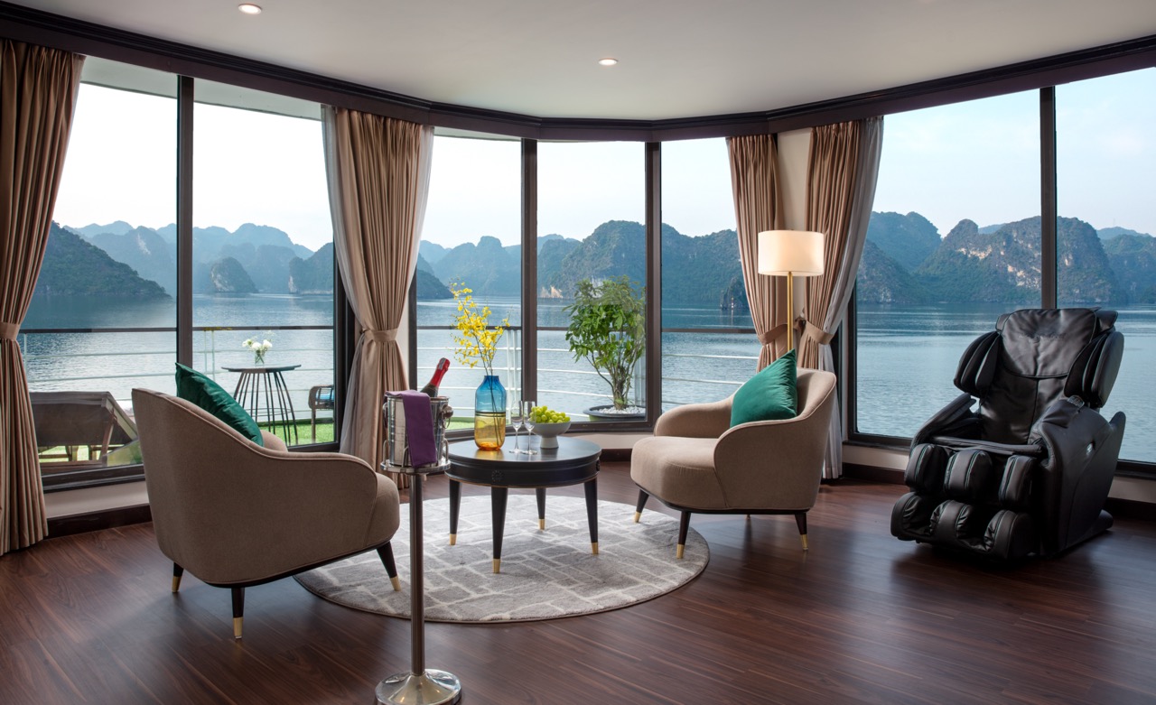 Luxurious cruise lounge with panoramic views of Halong Bay, perfect for relaxing and enjoying the st.