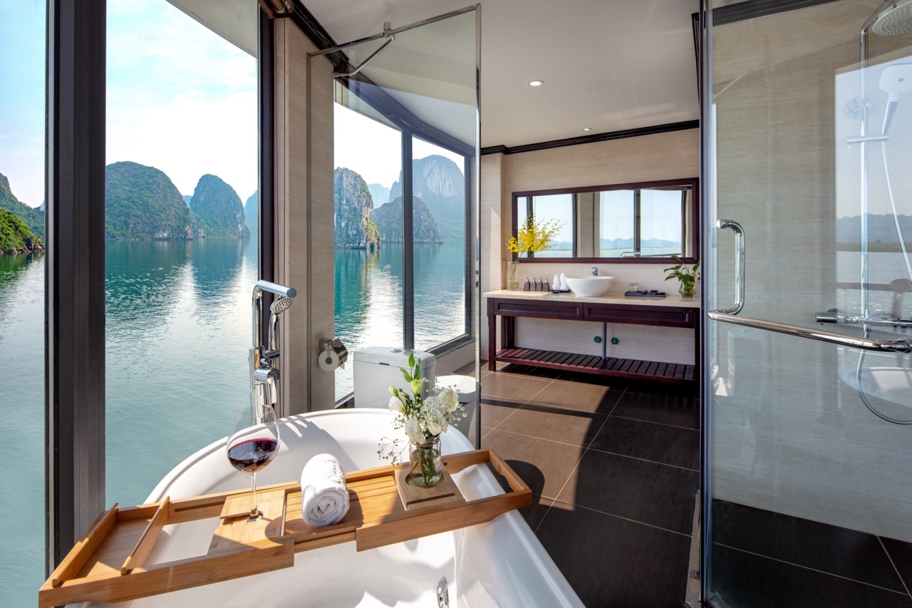 Stunning view from a cruise balcony in Halong Bay, showcasing serene waters and limestone karsts, pe.