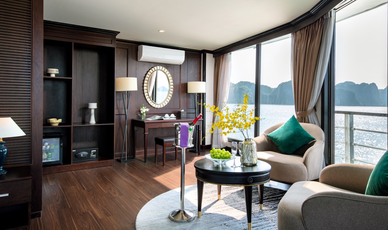 Stunning view of Halong Bay from a cruise balcony with elegant interior and panoramic windows.