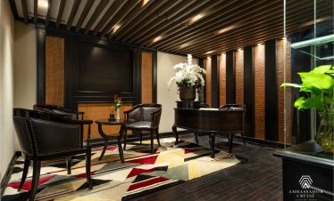 Relaxing cruise lounge with stylish seating and ambient lighting, ideal for enjoying Halong Bay view.