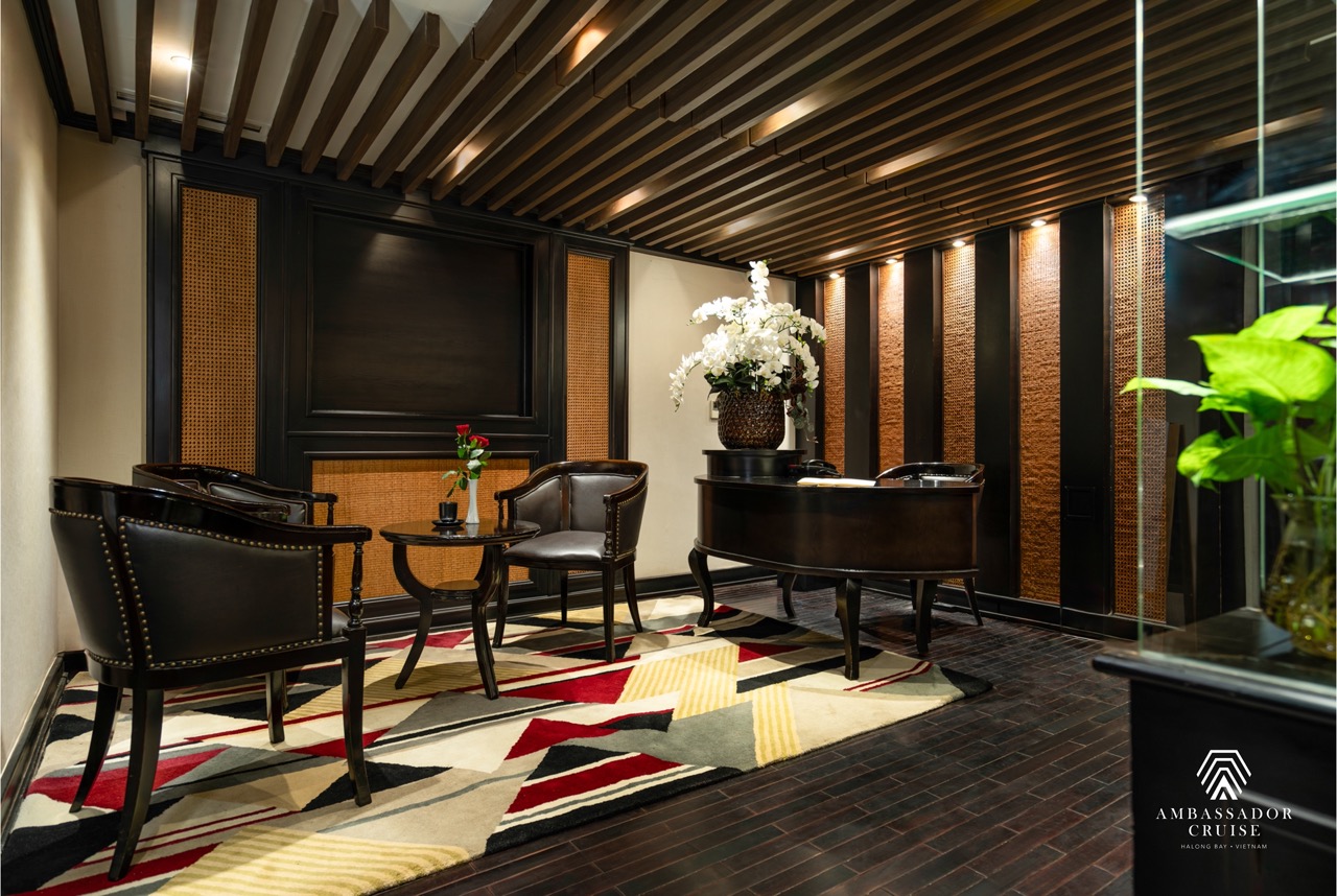 Relaxing cruise lounge with stylish seating and ambient lighting, ideal for enjoying Halong Bay view.