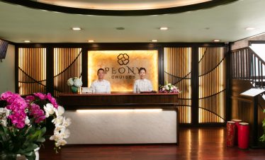 Elegant cruise check-in area with welcoming staff at Halong Bay.