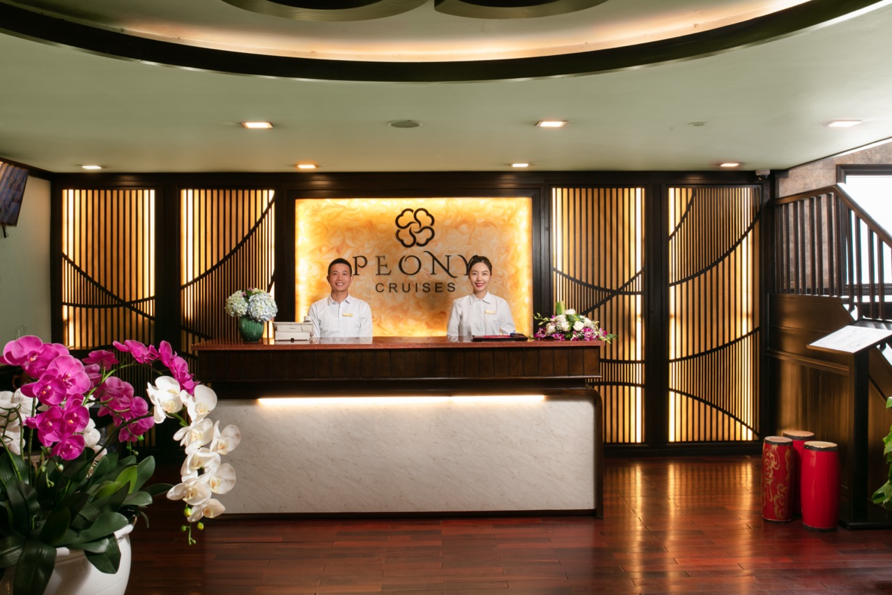 Elegant cruise check-in area with welcoming staff at Halong Bay.
