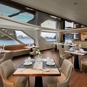 Luxurious onboard restaurant with panoramic sea views and elegant dining setup onboard a cruise ship.