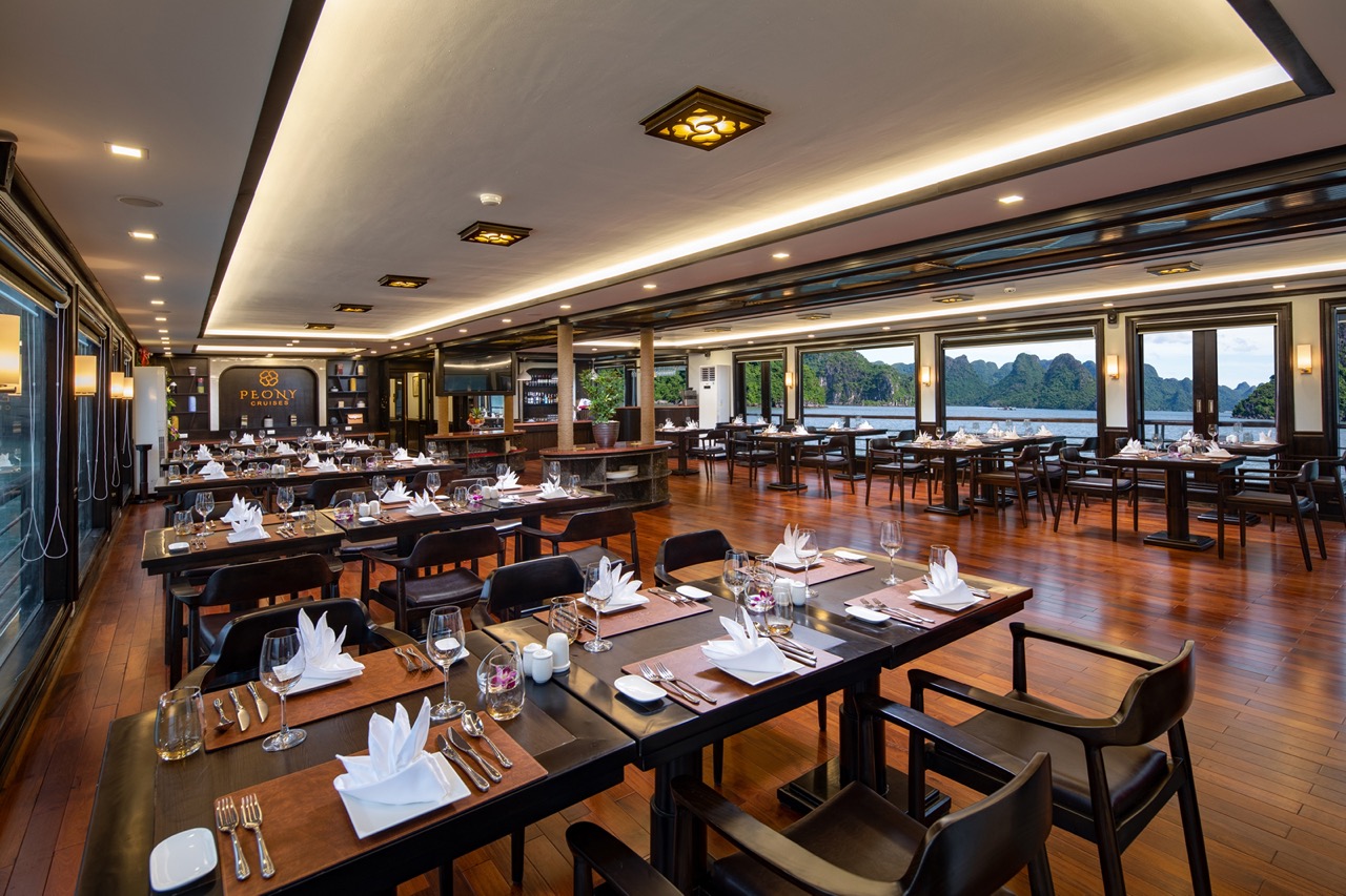 Elegant dining room on Peony Cruise in Halong Bay with panoramic views and luxurious ambiance.
