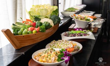 Elegant dining setup on Ambassador Cruise in Halong Bay with fresh seafood and scenic views.