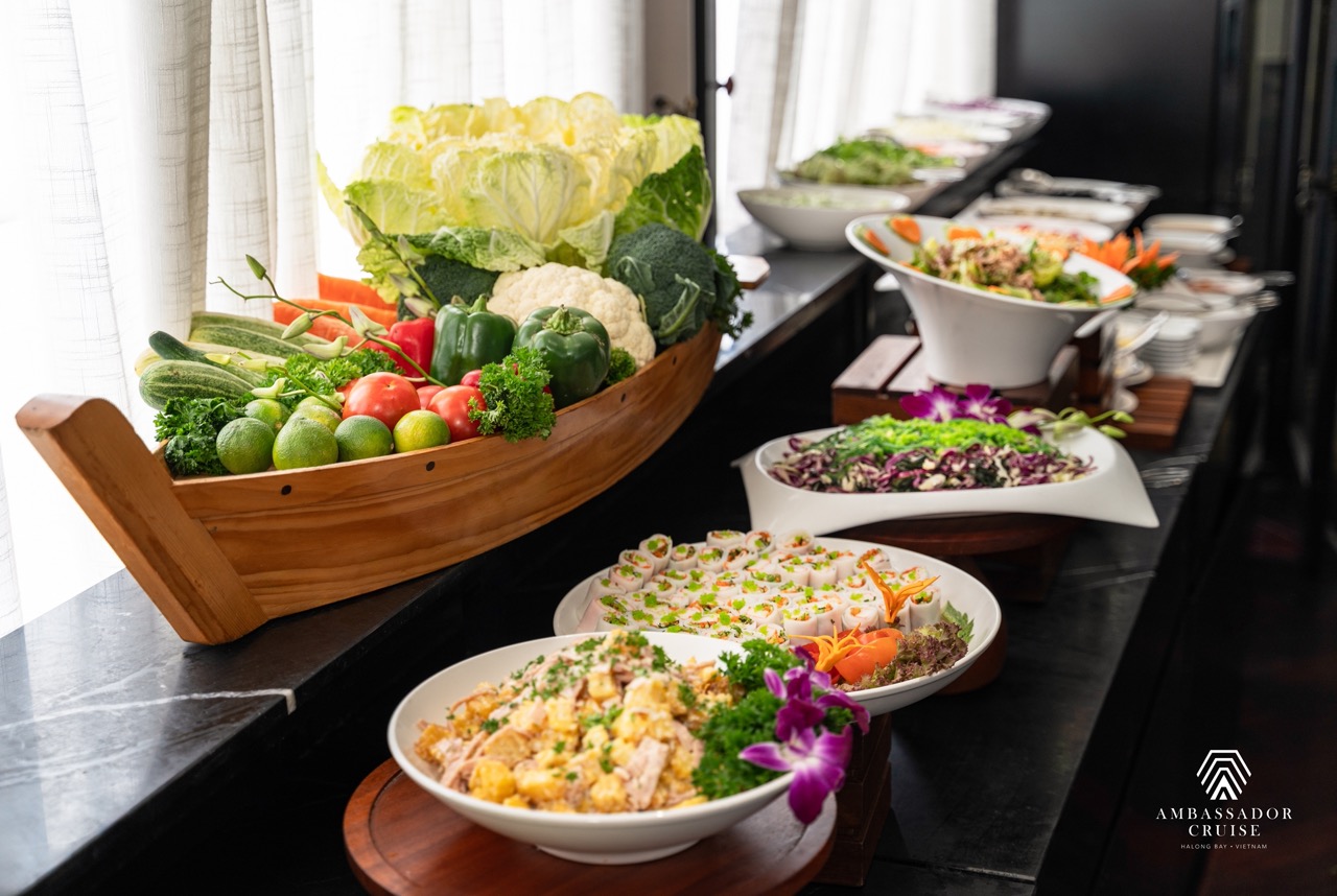 Elegant dining setup on Ambassador Cruise in Halong Bay with fresh seafood and scenic views.