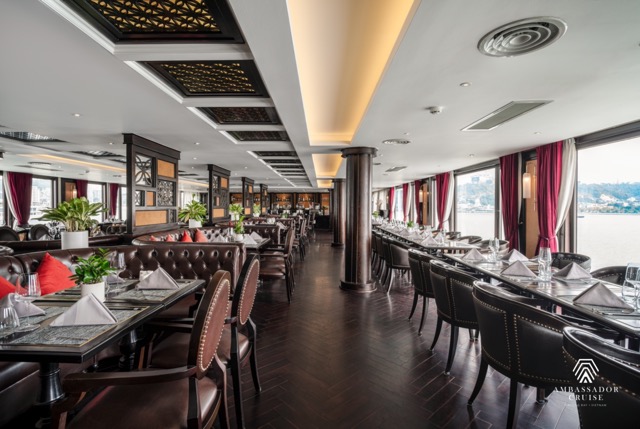 Elegant cruise balcony overlooking Halong Bay with calm waters and scenic karst formations.