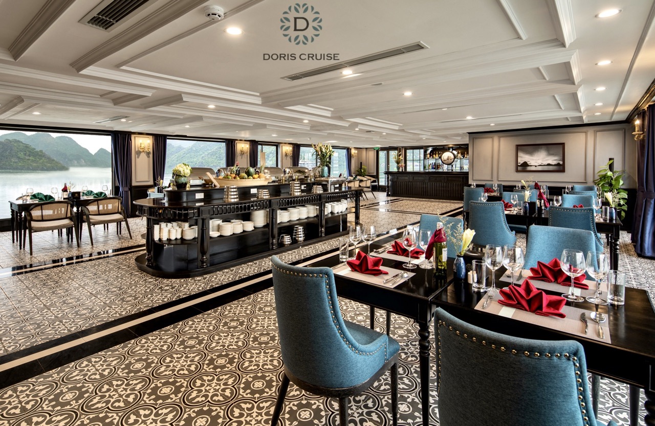 Luxurious cruise dining area with panoramic Halong Bay views, ideal for high-end travel and relaxati.