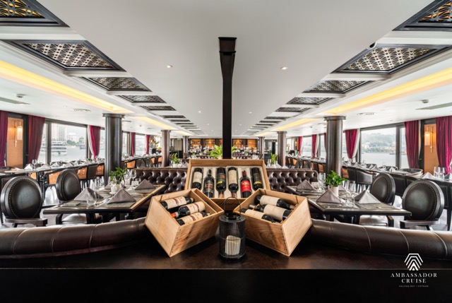 Elegant cruise lounge with panoramic windows and stylish decor in Halong Bay.