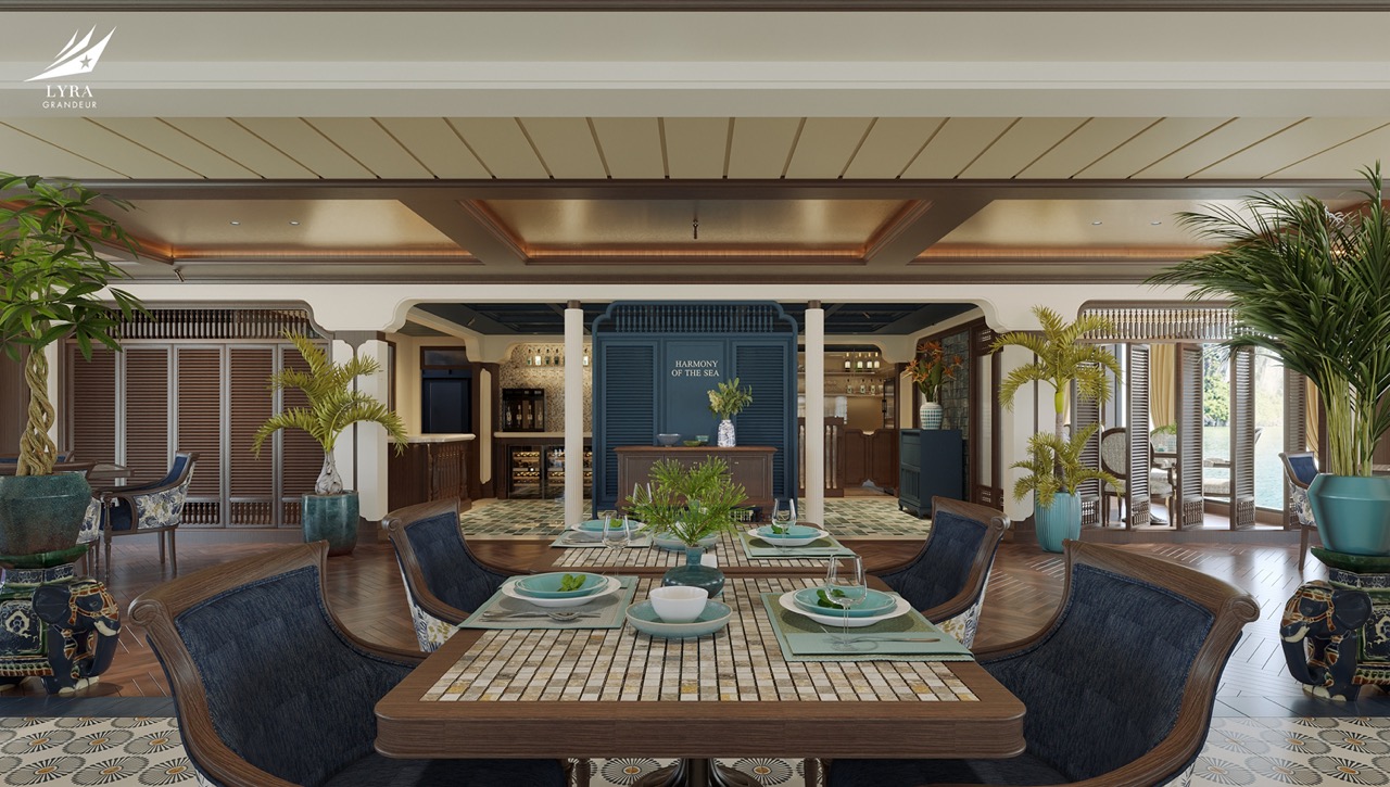 Elegant dining room at ViettrendTour resort with lush tropical plants and sea view decor.