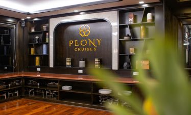 Luxurious cruise lounge with elegant decor and branding, perfect for a relaxing Halong Bay 2D1N expe.