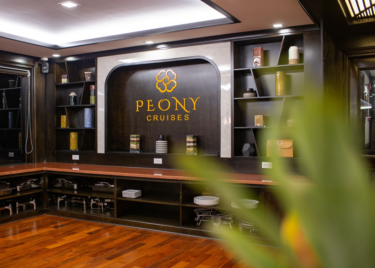 Luxurious cruise lounge with elegant decor and branding, perfect for a relaxing Halong Bay 2D1N expe.
