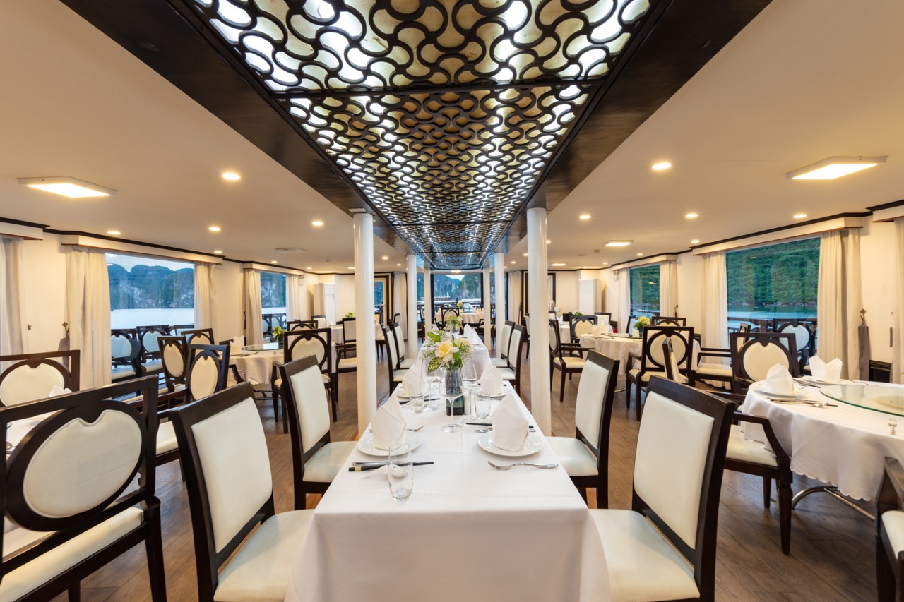 Luxurious restaurant interior with elegant dining setup and lake views.