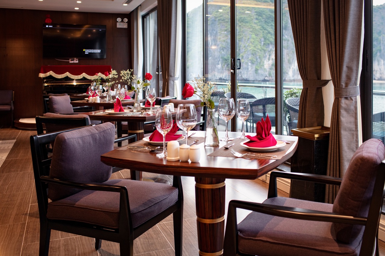 Luxurious restaurant dining with lake views, elegant table setting, and red accents for romantic meals.
