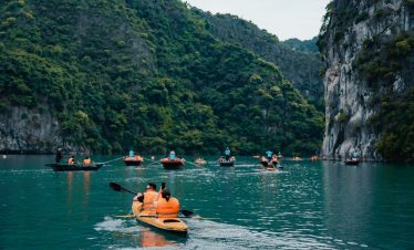 Kayaking in Halong Bay with scenic limestone karsts and tranquil waters, perfect for an adventurous.