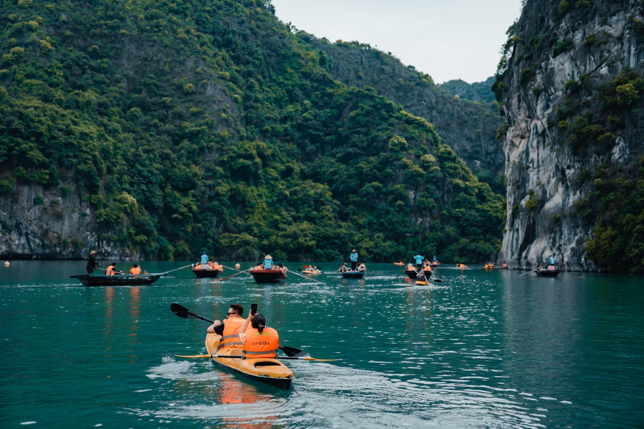 Kayaking in Halong Bay with scenic limestone karsts and tranquil waters, perfect for an adventurous.