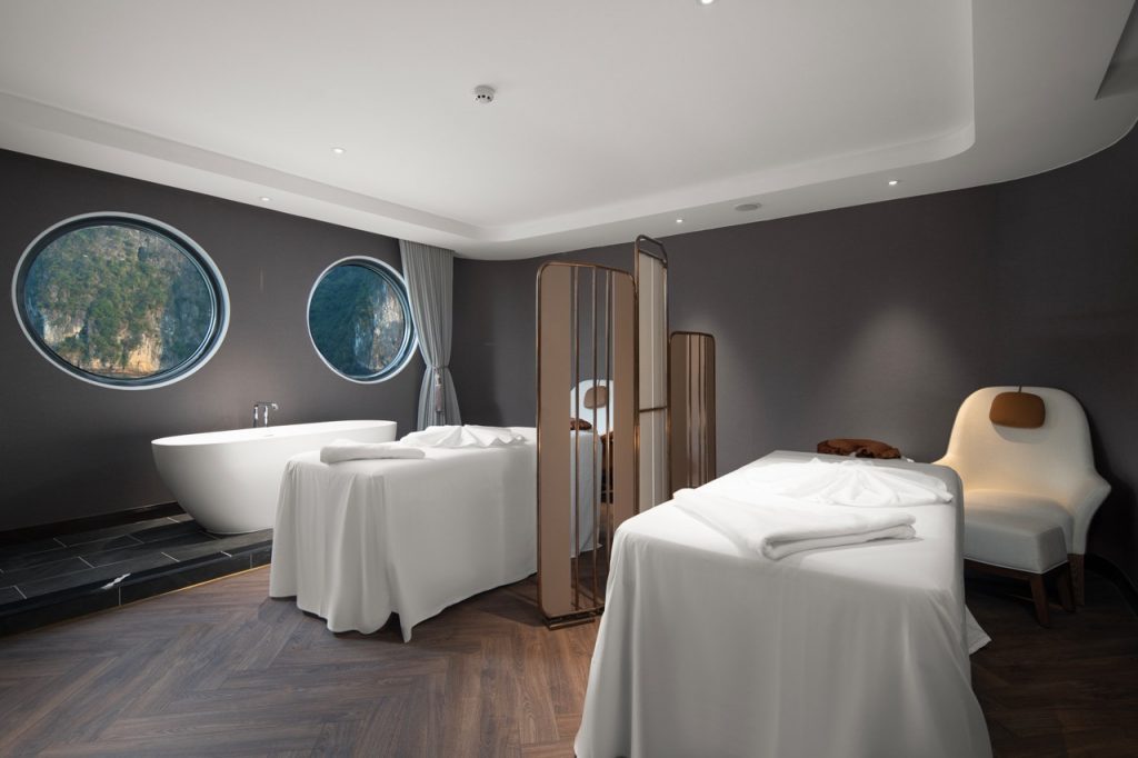 Luxurious spa hotel room with modern decor and panoramic mountain views.