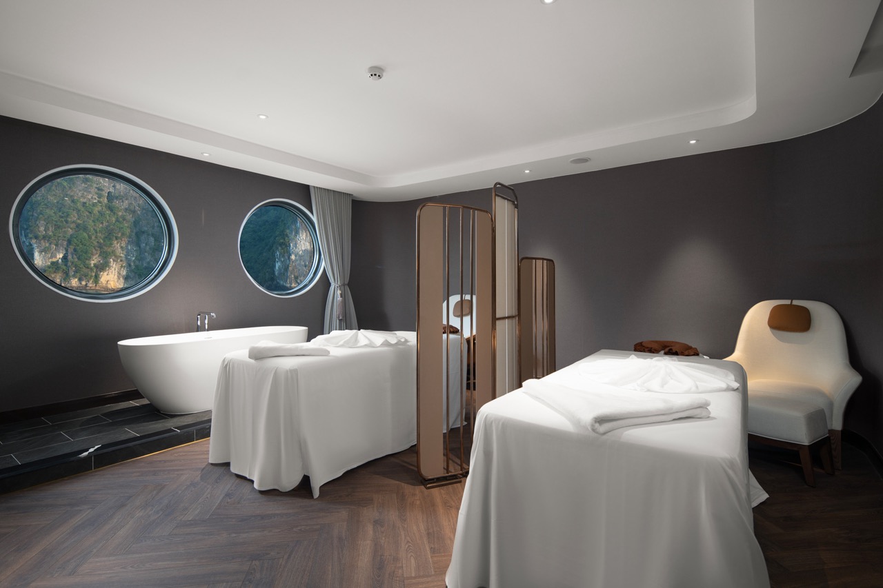 Luxurious spa hotel room with modern decor and panoramic mountain views.