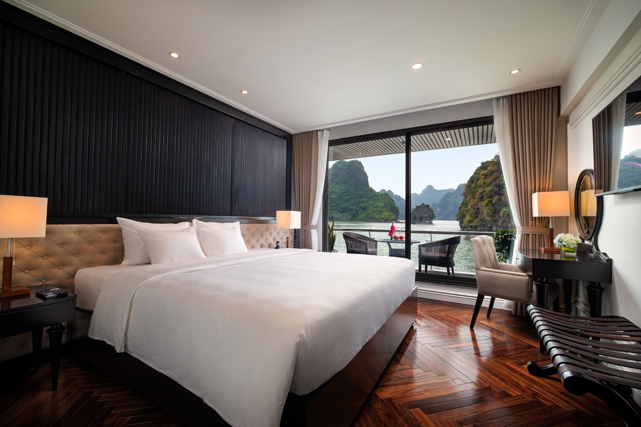 Luxurious hotel bedroom with river view and mountain scenery in Vietnam.
