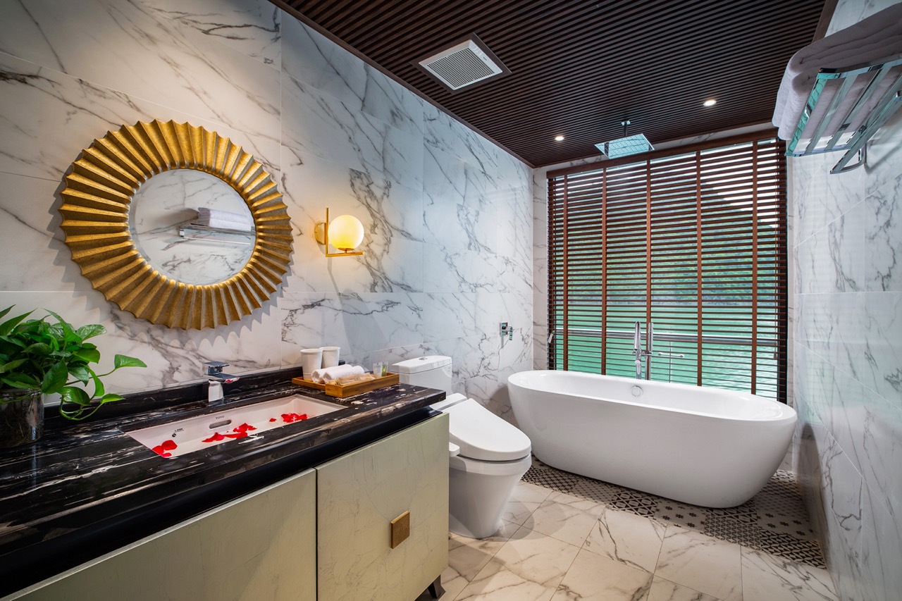 Luxurious marble bathroom with freestanding bathtub and modern decor, perfect for relaxation.