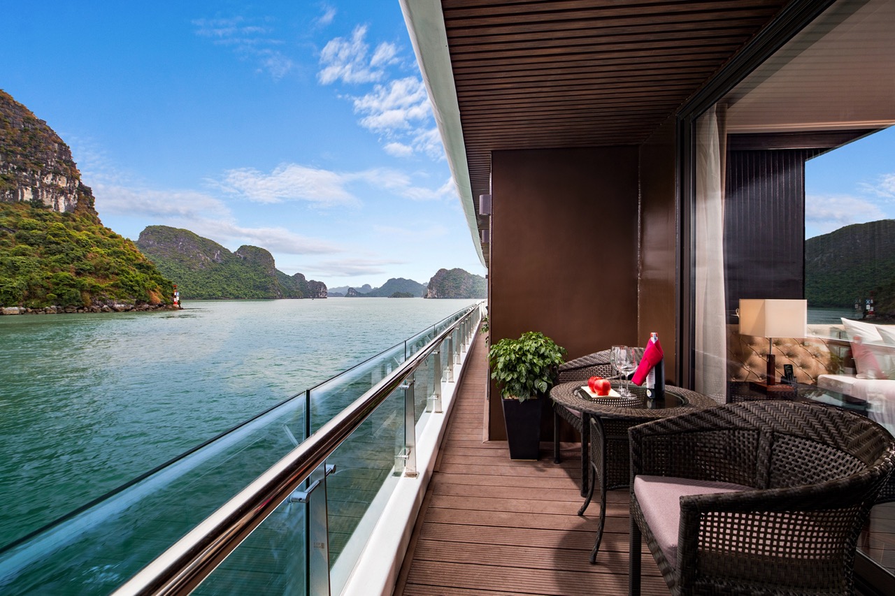 Luxury cruise balcony overlooking karst mountains in Halong Bay, Vietnam.