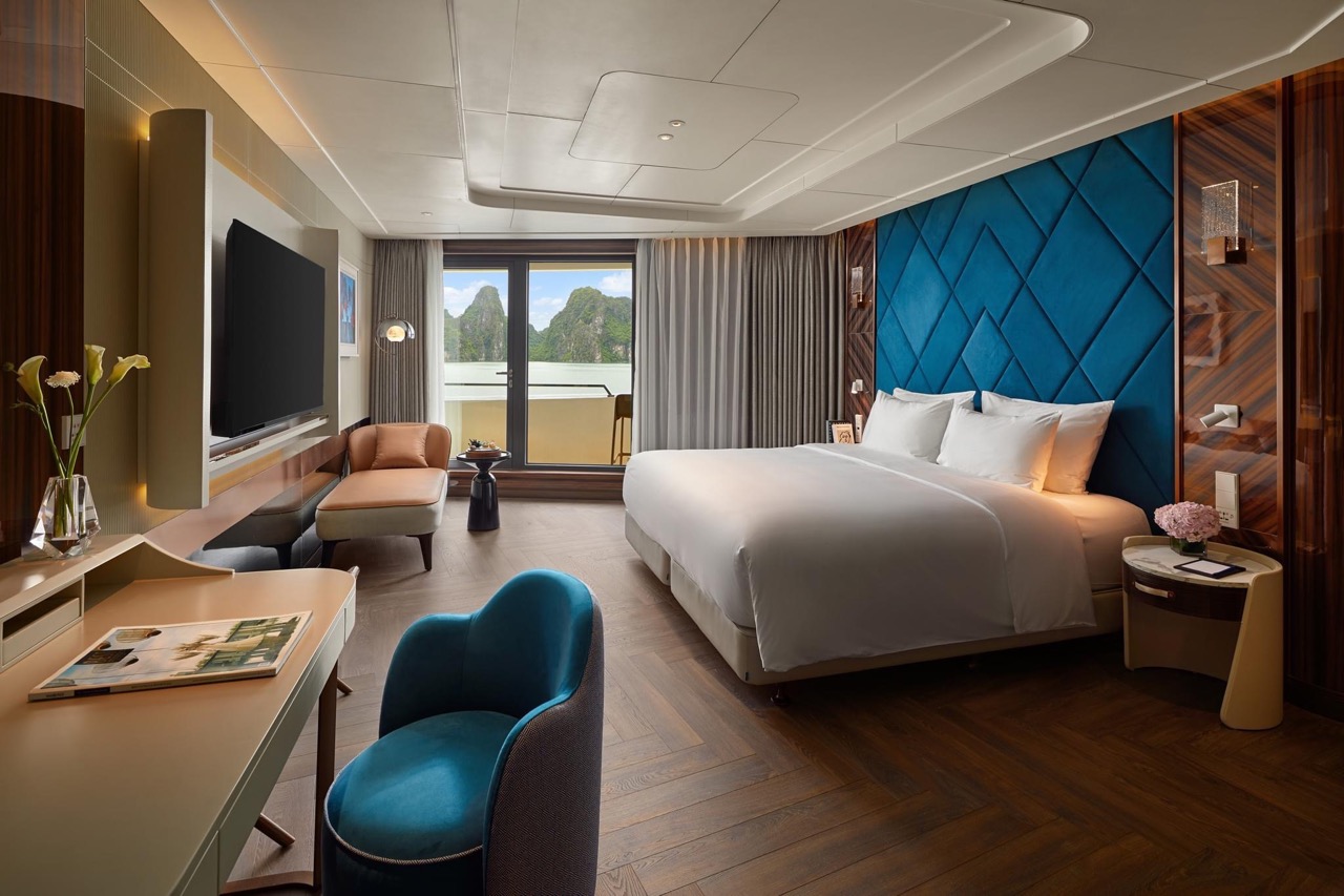 Luxury hotel room with king-sized bed and mountain view in Vietnam.