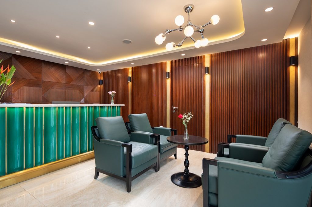 Modern hotel lobby with elegant wood paneling and stylish seating for travelers and guests.