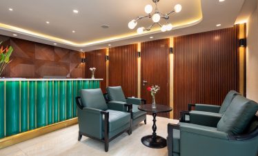 Modern hotel lobby with elegant wood paneling and stylish seating for travelers and guests.