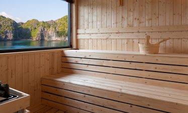 Relaxing indoor sauna with scenic mountain lake view in Vietnam.