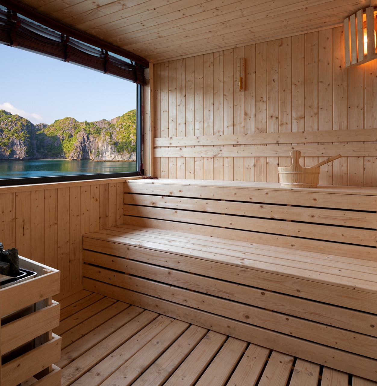 Relaxing indoor sauna with scenic mountain lake view in Vietnam.