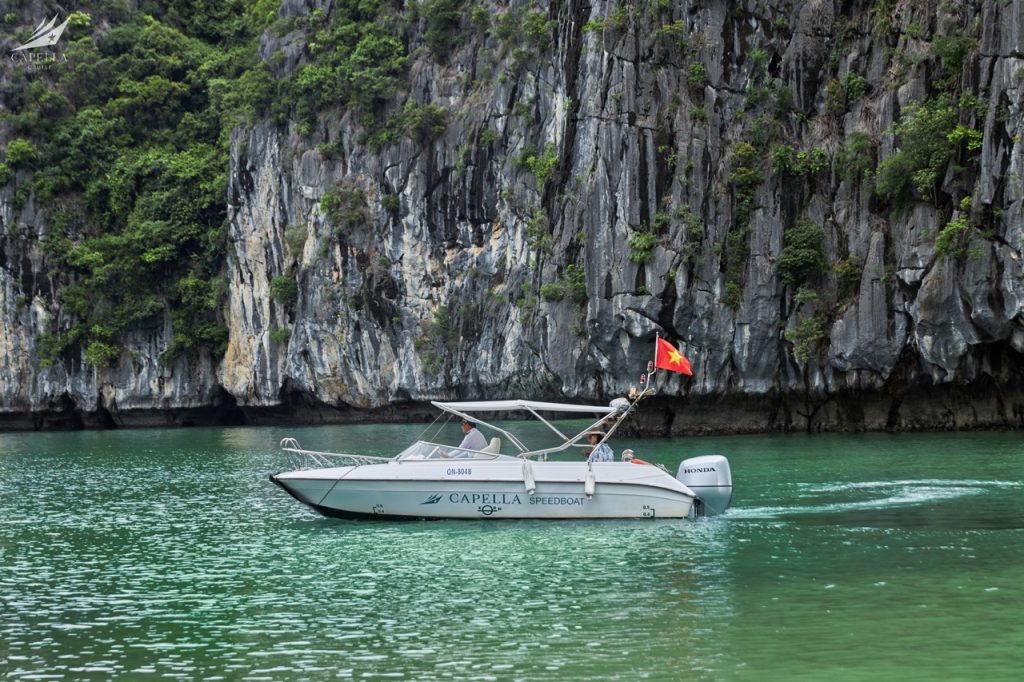 Relaxing boat cruise among limestone karsts in Halong Bay, Vietnam.