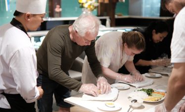 Enjoying a cooking class on a Halong Bay catamaran cruise with scenic views and cultural experience.