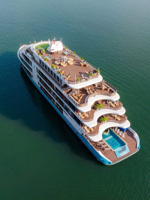 Luxury cruise ship with outdoor pools and panoramic decks for vacation travel.
