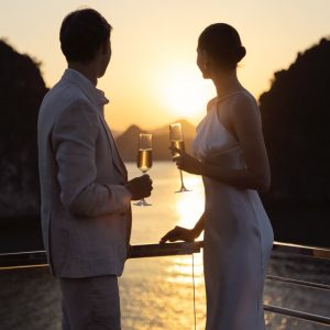 sundeck-champagne-sunset-couple-grand-pioneers-cruise-halong-bay-viettrendtour