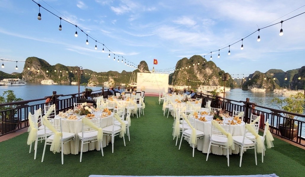Luxurious outdoor dining overlooking Ha Long Bay in Vietnam, perfect for events and celebrations.