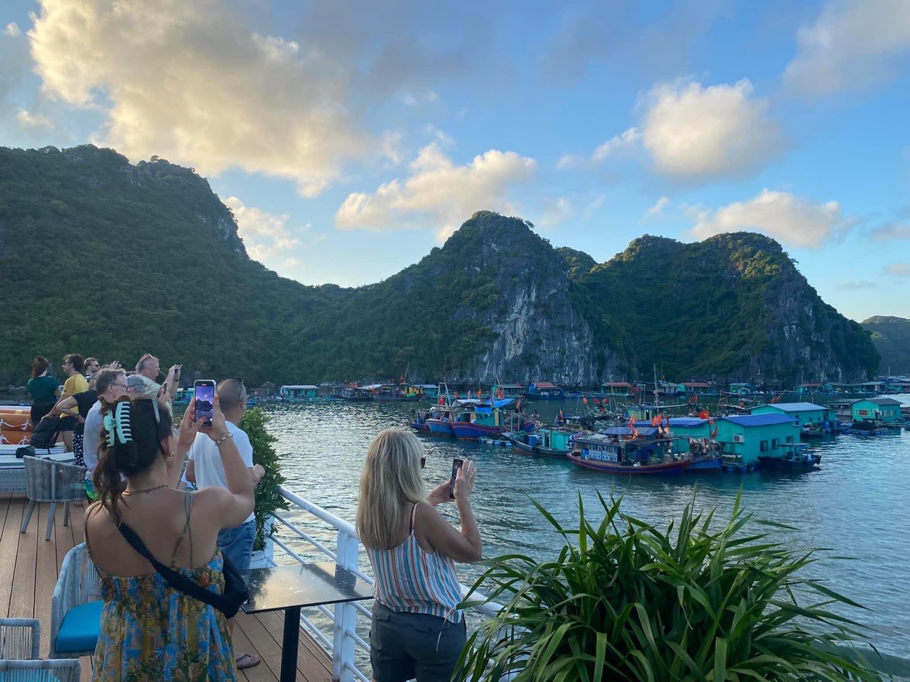 Halong Bay cruise balcony with scenic mountain views and tranquil waters.