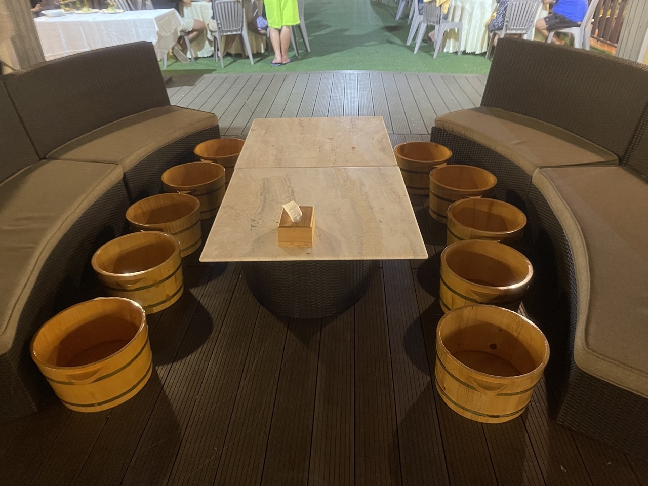Soaking Tub Buckets for Fruit Bath, Rattan Sofas, and Marble Table at ViettrendTour Restaurant.
