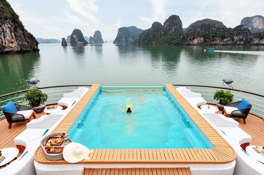 Stunning view of Halong Bay from a cruise balcony with limestone karsts and calm waters, perfect for.