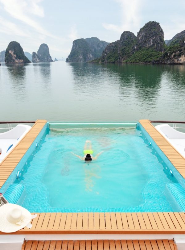 Stunning view of Halong Bay from a cruise balcony with limestone karsts and calm waters, perfect for.