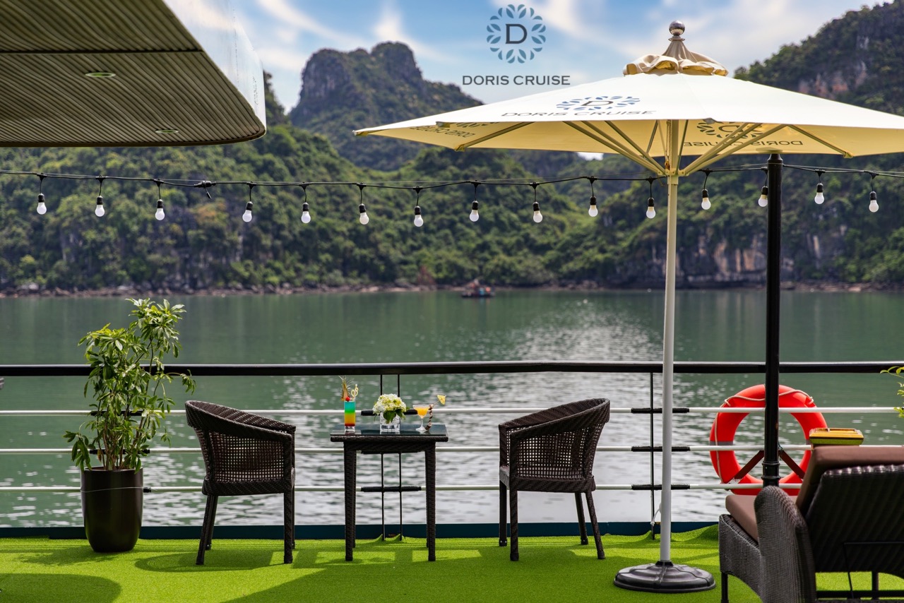 Stunning Halong Bay scenery with luxurious cruise balcony, perfect for relaxing and enjoying the maj.
