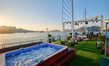 Luxury Halong Bay cruise balcony with hot tub and scenic views.
