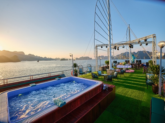 Luxury Halong Bay cruise balcony with hot tub and scenic views.