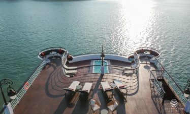 Stunning view from a cruise balcony in Halong Bay, showcasing calm waters and scenic landscape, perf.