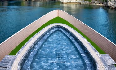 Stunning view from cruise balcony overlooking Halong Bay's emerald waters and limestone karsts.