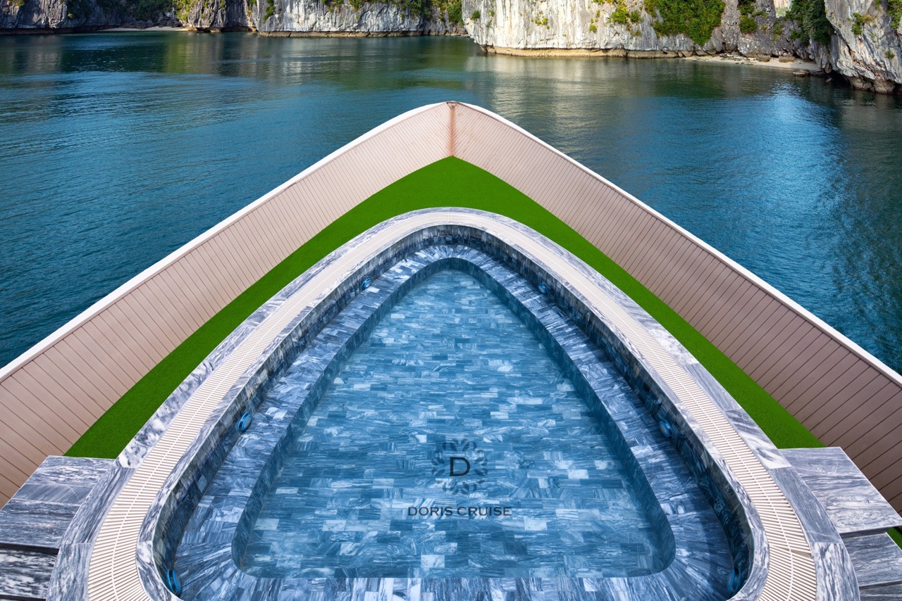 Stunning view from cruise balcony overlooking Halong Bay's emerald waters and limestone karsts.